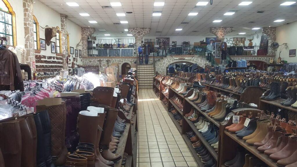 Boots and other clothing items at a store.