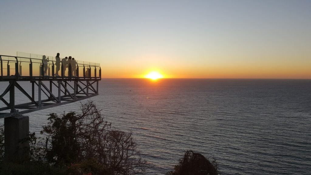 A glass-bottomed lookout at sunset.