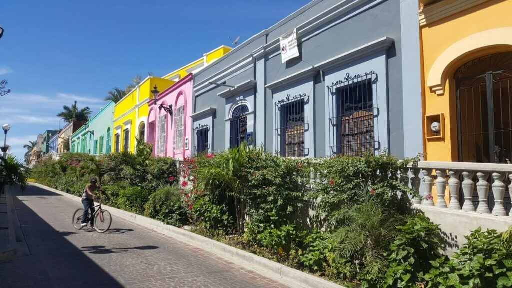 A man riding a bike on a colorful street.