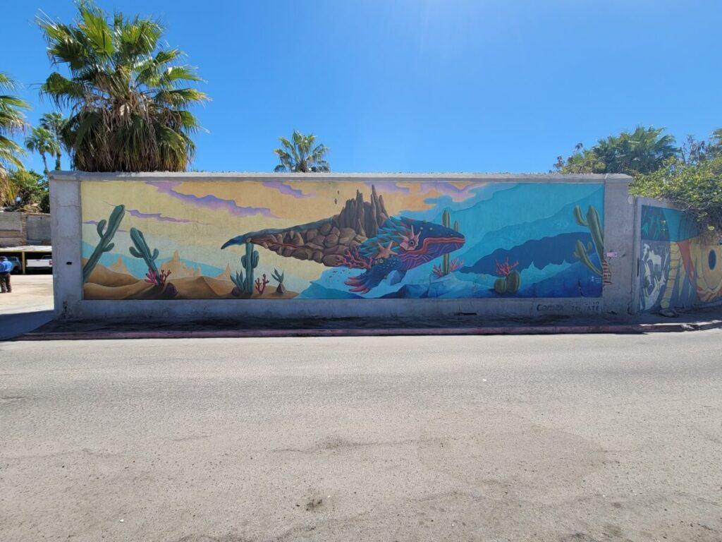 A colorful mural depicting a whale.