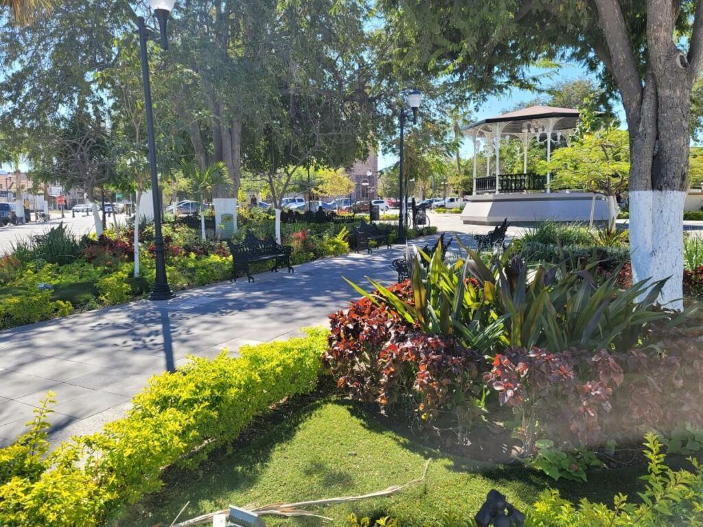 A plaza with gardens and a gazebo.